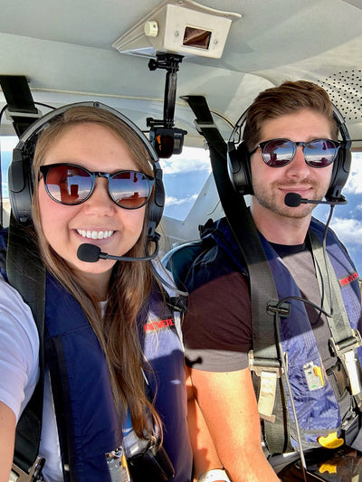 Fly Me To The Fun wearing circular glasses in a Cessna